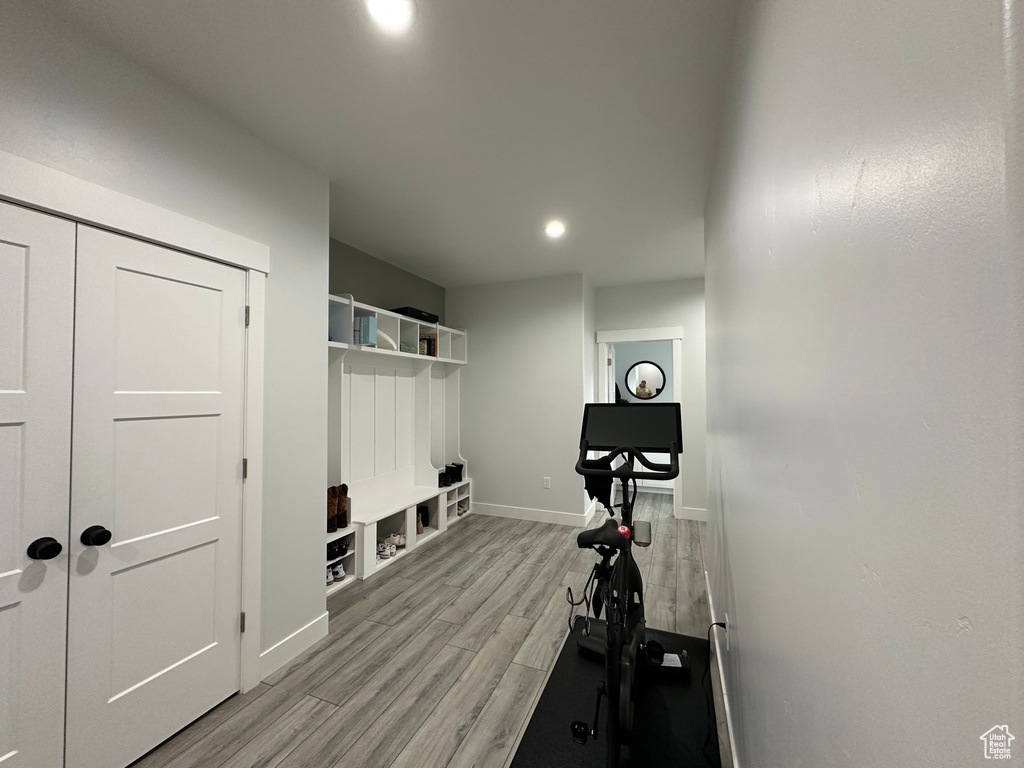 Exercise area featuring recessed lighting, baseboards, and light wood finished floors