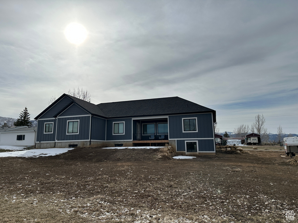 View of front of property with covered porch and a shingled roof