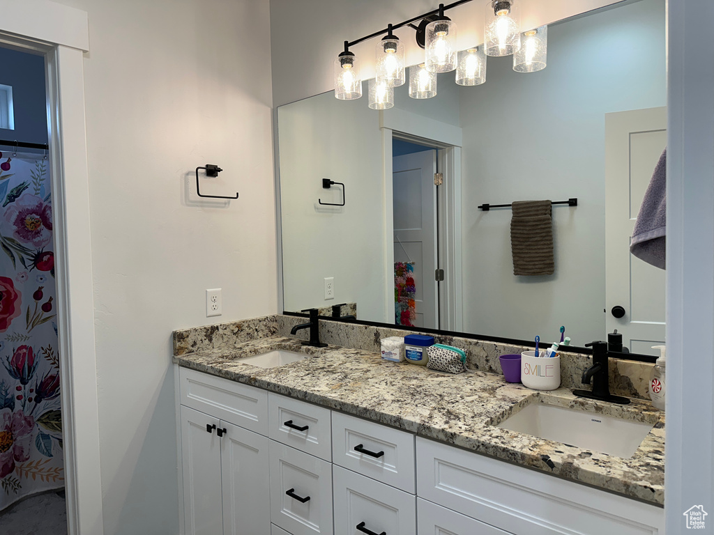 Full bath with a sink and double vanity