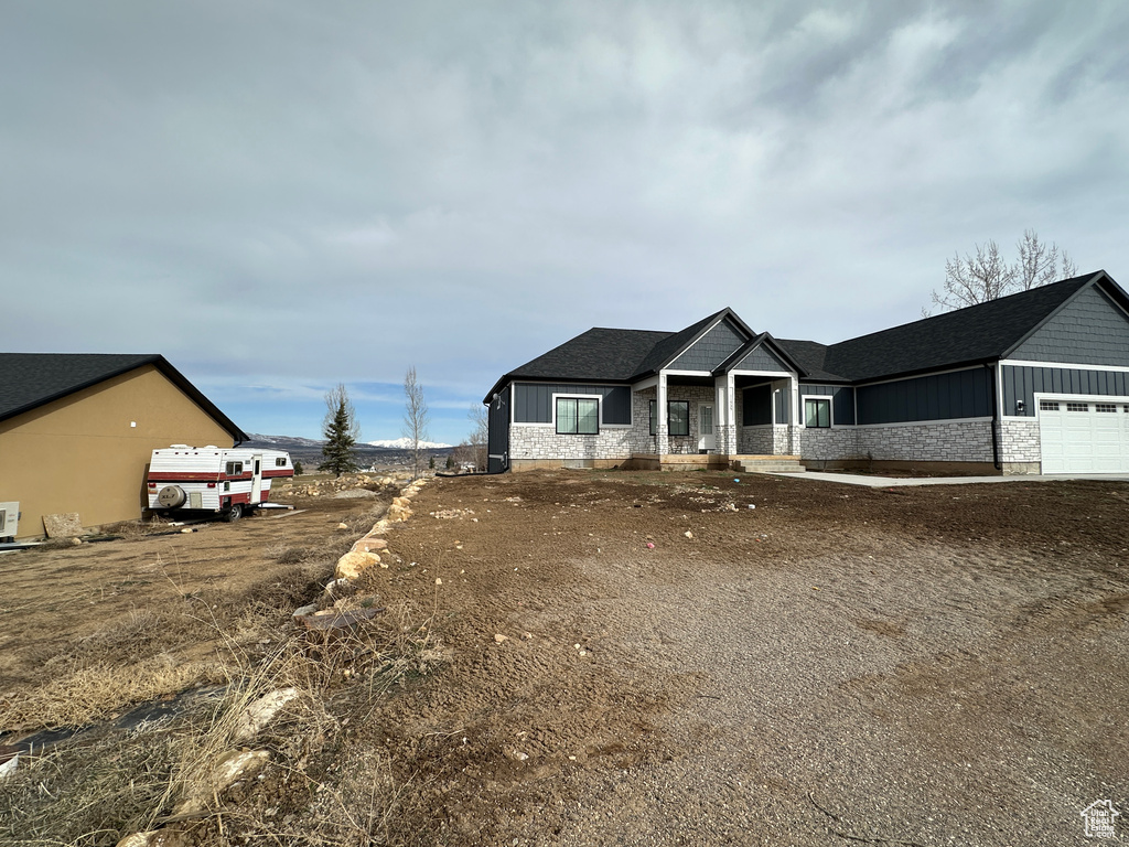 View of front of house featuring board and batten siding and an attached garage