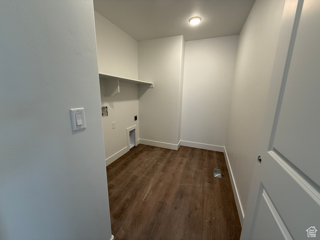 Laundry area featuring dark wood finished floors, laundry area, baseboards, and hookup for an electric dryer