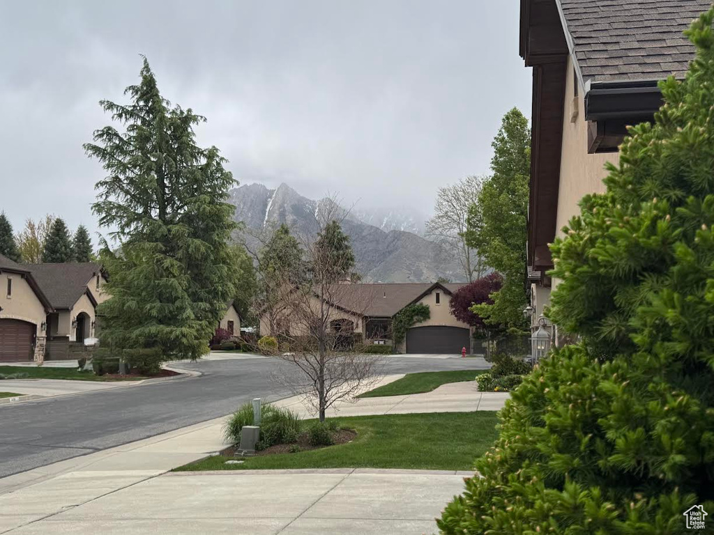 View of asphalt road with a mountain view and sidewalks