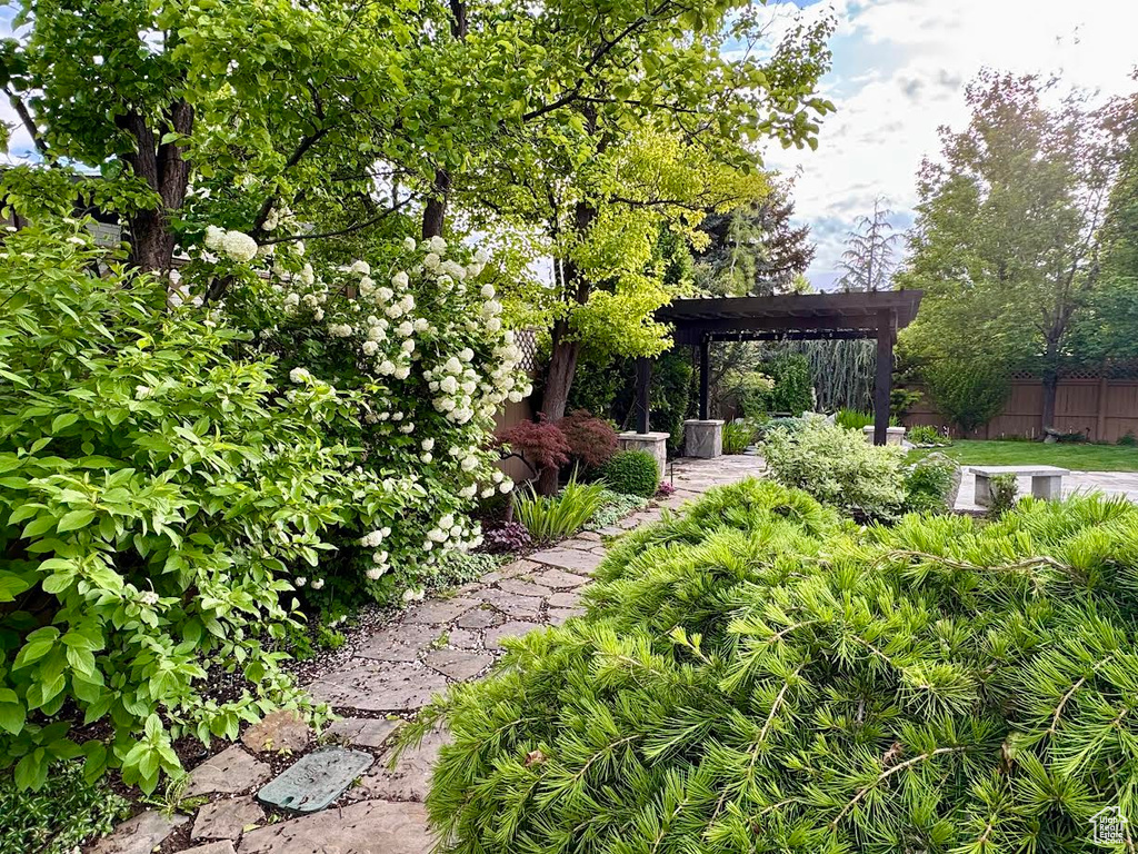 View of yard featuring a pergola and fence