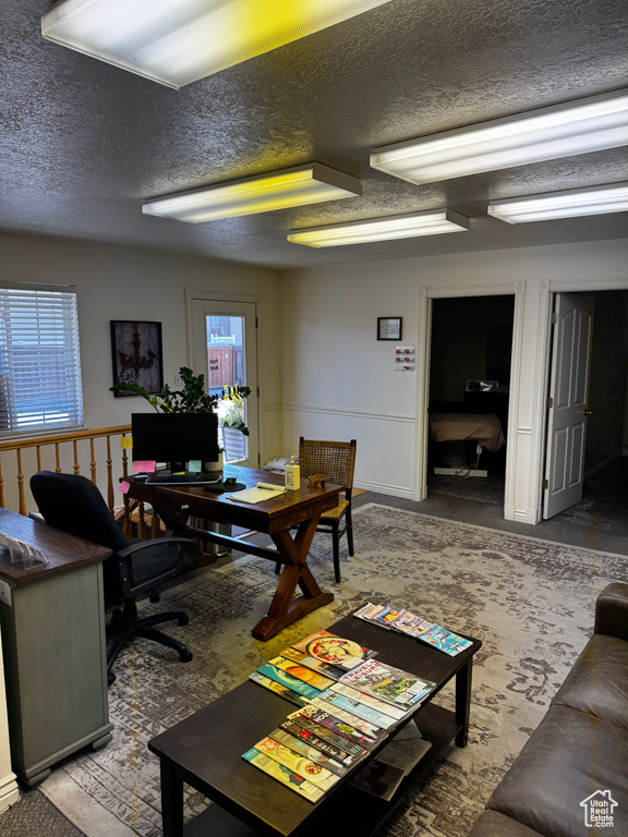 Home office featuring a textured ceiling