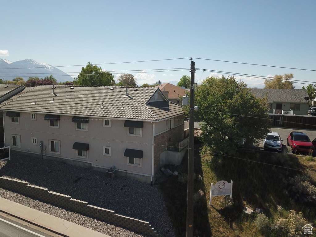 Exterior space with central air condition unit and a tile roof