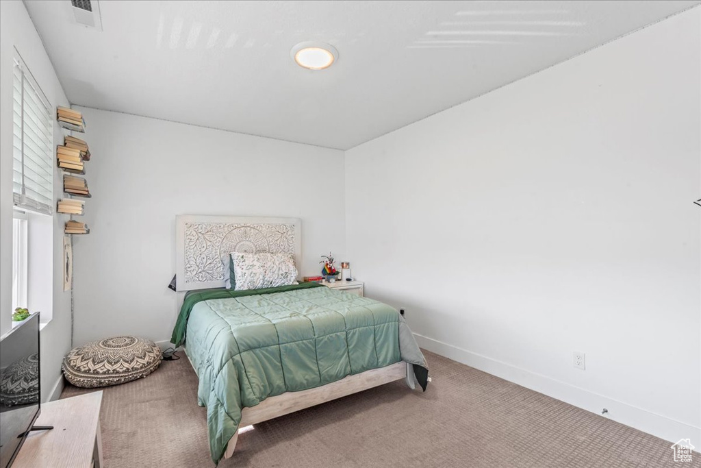 Carpeted bedroom with baseboards