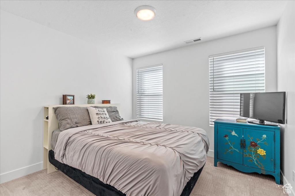 Carpeted bedroom featuring baseboards