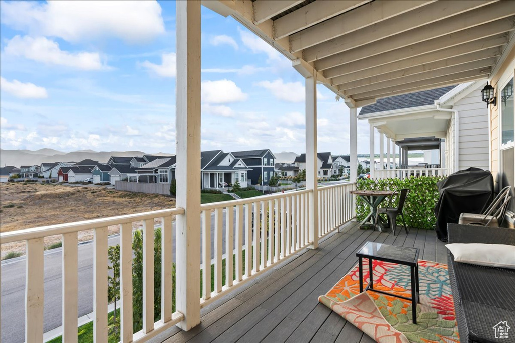 Deck featuring a residential view and a grill