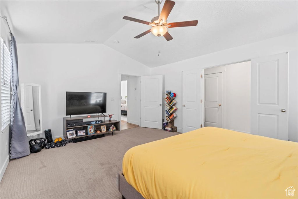 Bedroom featuring vaulted ceiling, a ceiling fan, and baseboards