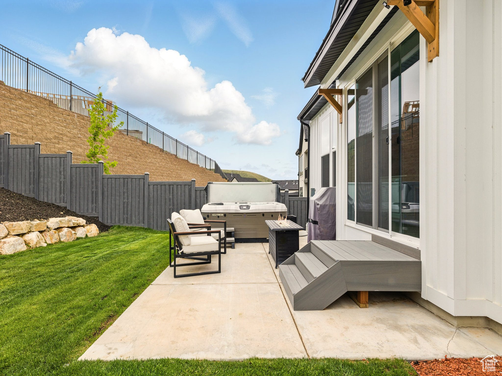 View of patio with a wooden deck