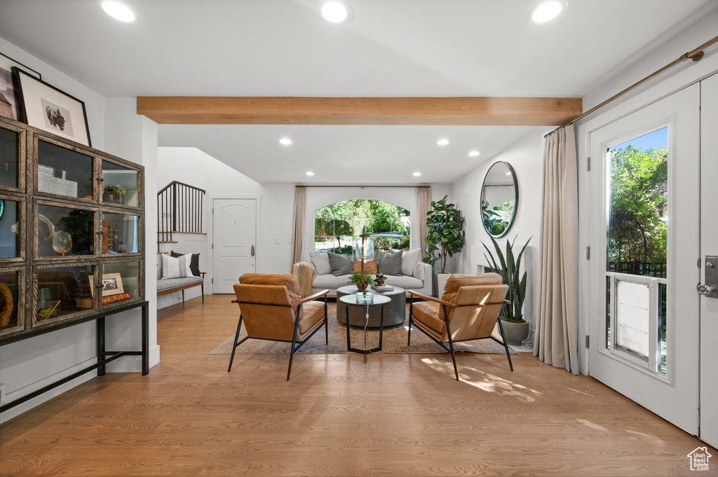 Living room featuring recessed lighting, vaulted ceiling with beams, and light wood-style floors