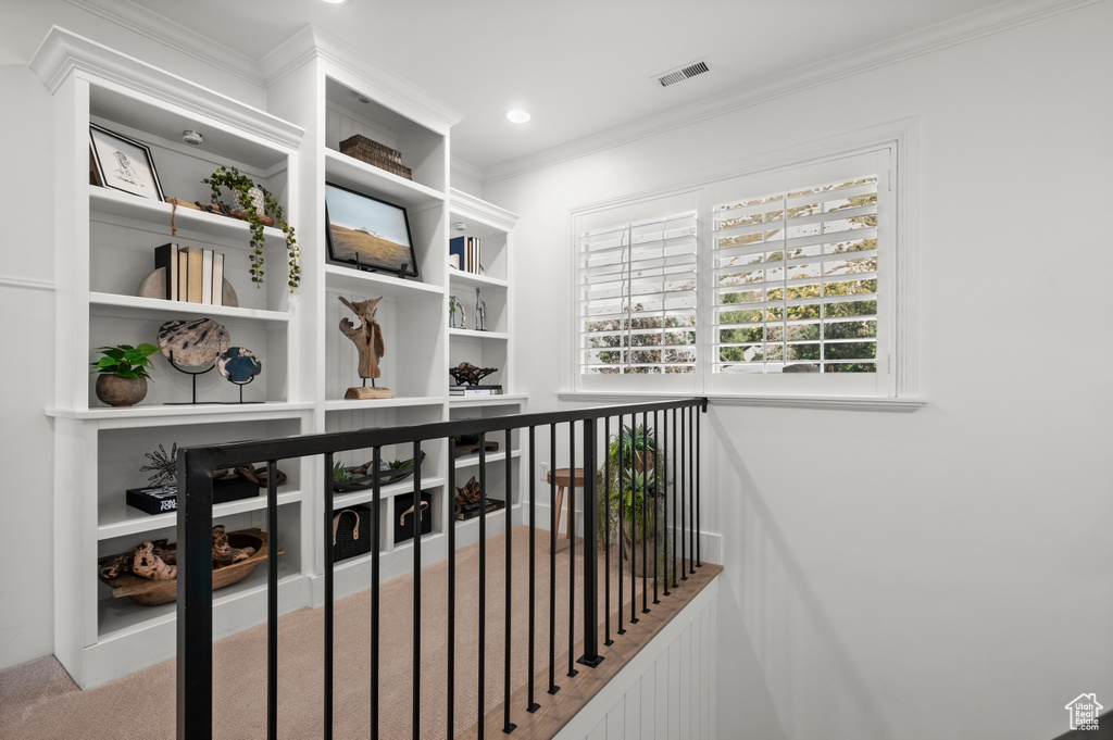 Interior space featuring crown molding, carpet flooring, recessed lighting, and visible vents