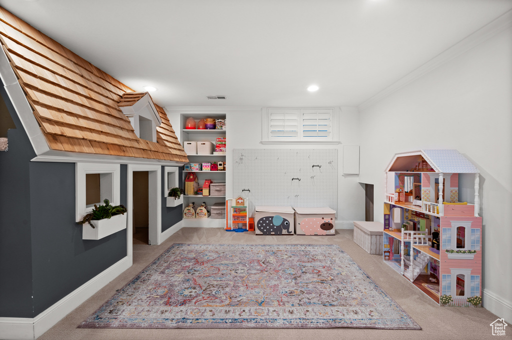 Rec room with visible vents, baseboards, carpet, and ornamental molding