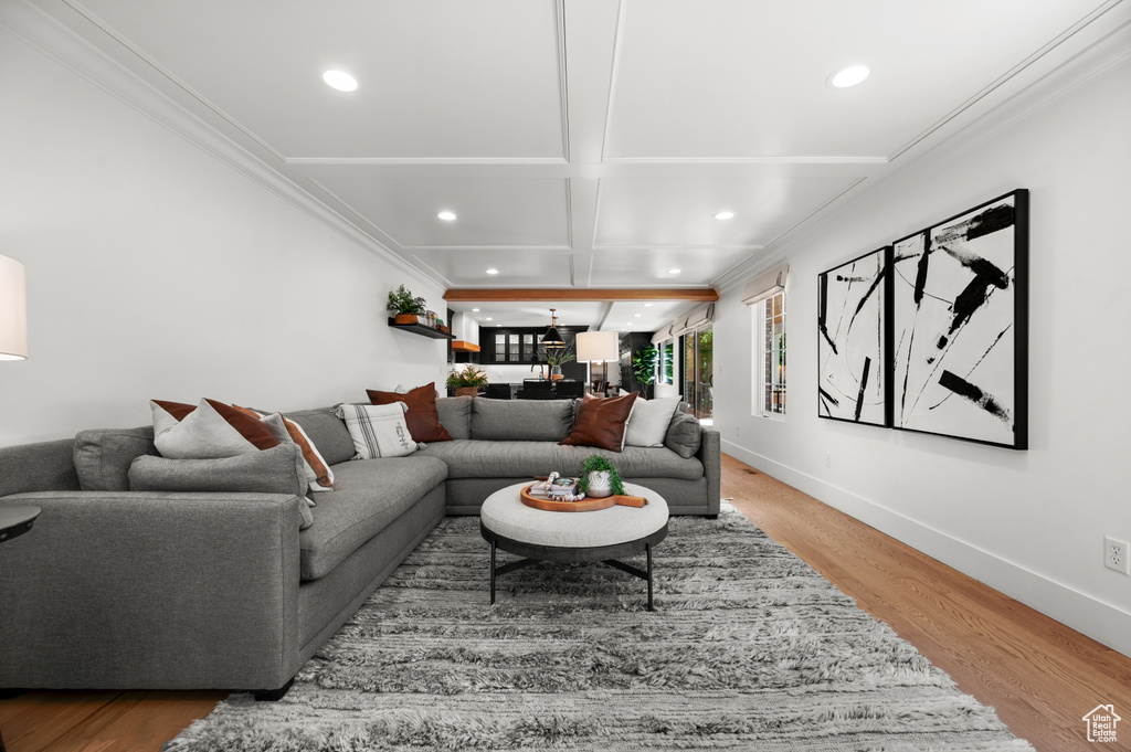 Living room with crown molding, recessed lighting, wood finished floors, and baseboards
