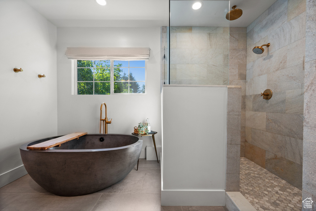 Bathroom featuring baseboards, recessed lighting, a freestanding bath, and walk in shower