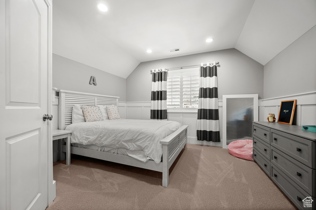 Bedroom with recessed lighting, light colored carpet, and vaulted ceiling