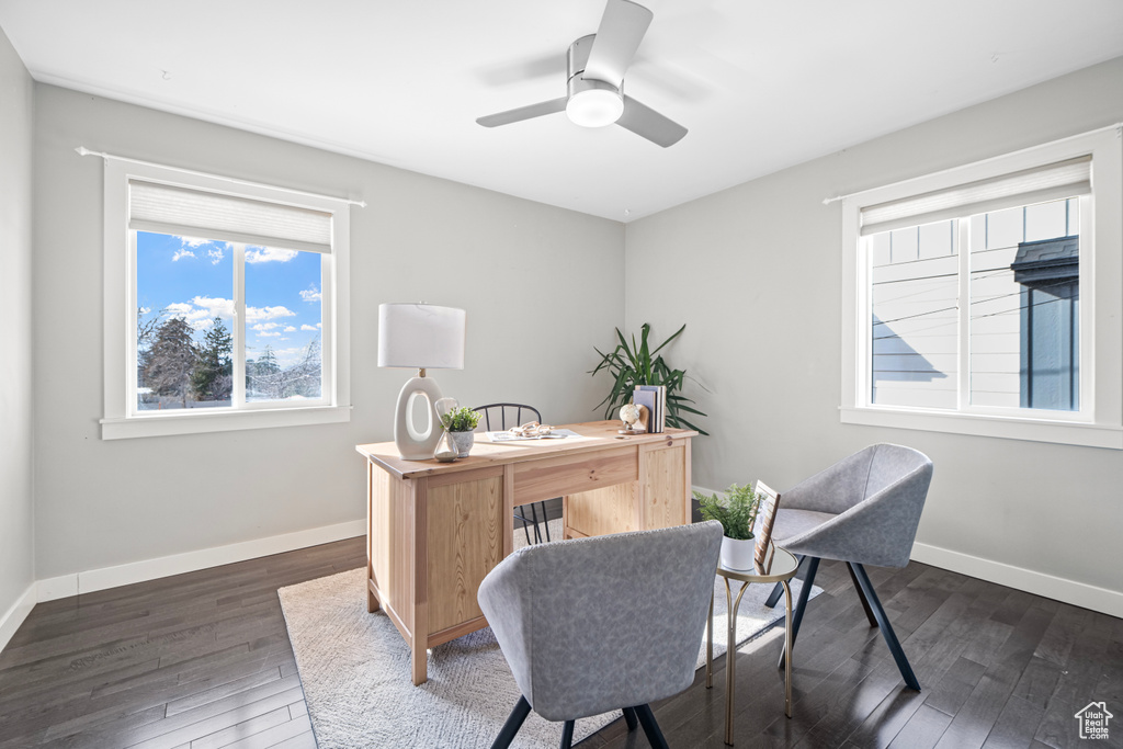 Office area featuring baseboards, dark wood finished floors, and a ceiling fan