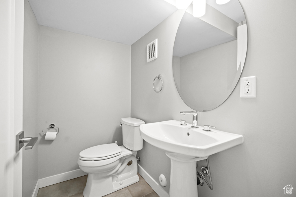 Bathroom with visible vents, baseboards, toilet, and tile patterned flooring