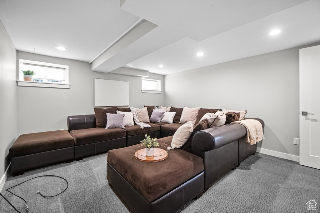 Carpeted living area with recessed lighting and baseboards