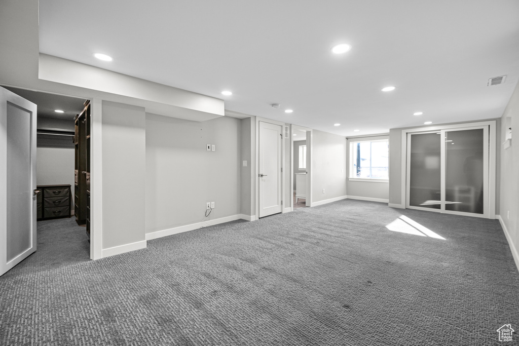 Below grade area with recessed lighting, carpet, visible vents, and baseboards