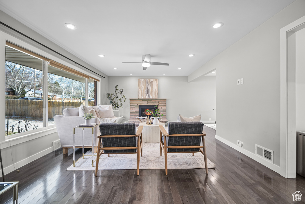 Living area featuring baseboards, visible vents, and dark wood-style flooring