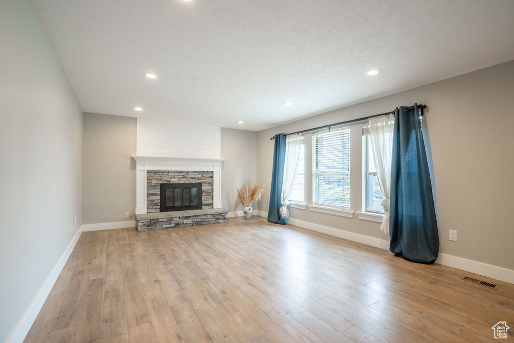 Unfurnished living room with visible vents, recessed lighting, baseboards, and wood finished floors