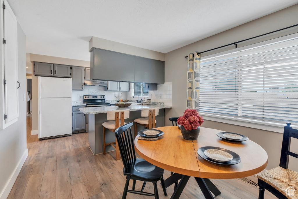 Dining room featuring baseboards and light wood-style flooring