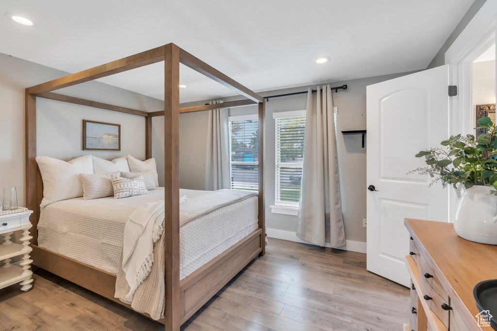Bedroom featuring light wood finished floors, recessed lighting, and baseboards