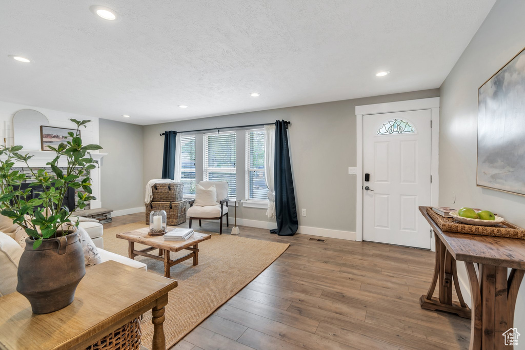 Foyer with recessed lighting, baseboards, and light wood finished floors