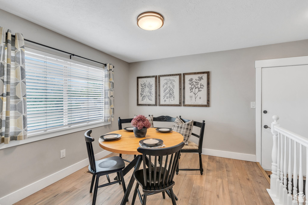 Dining space with baseboards and light wood finished floors