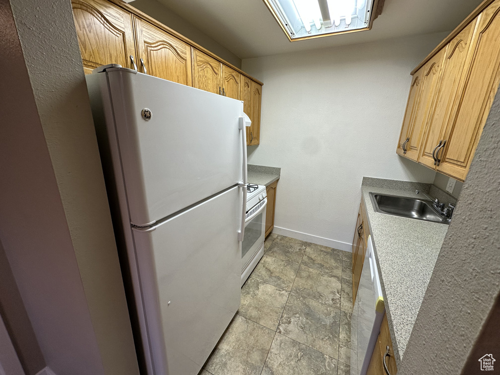 Kitchen featuring white appliances and light countertops