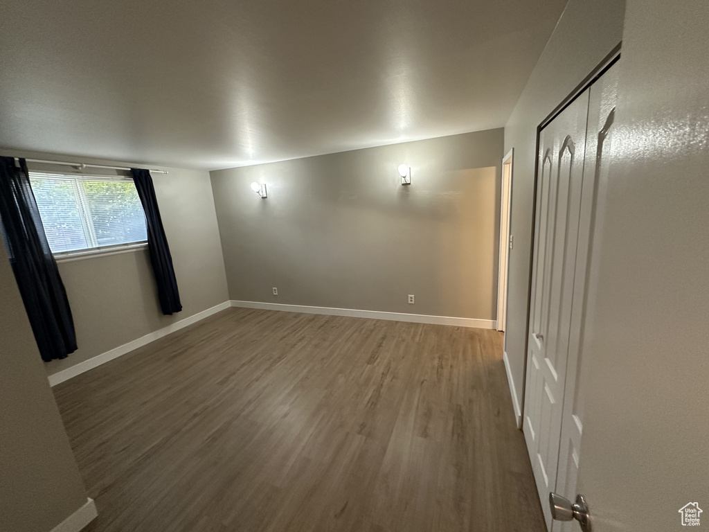 Spare room featuring wood finished floors and baseboards