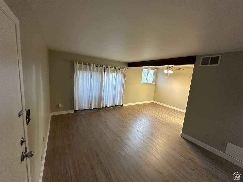 Spare room with wood finished floors and a ceiling fan