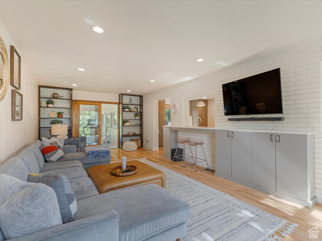 Living room with light hardwood / wood-style flooring and sink