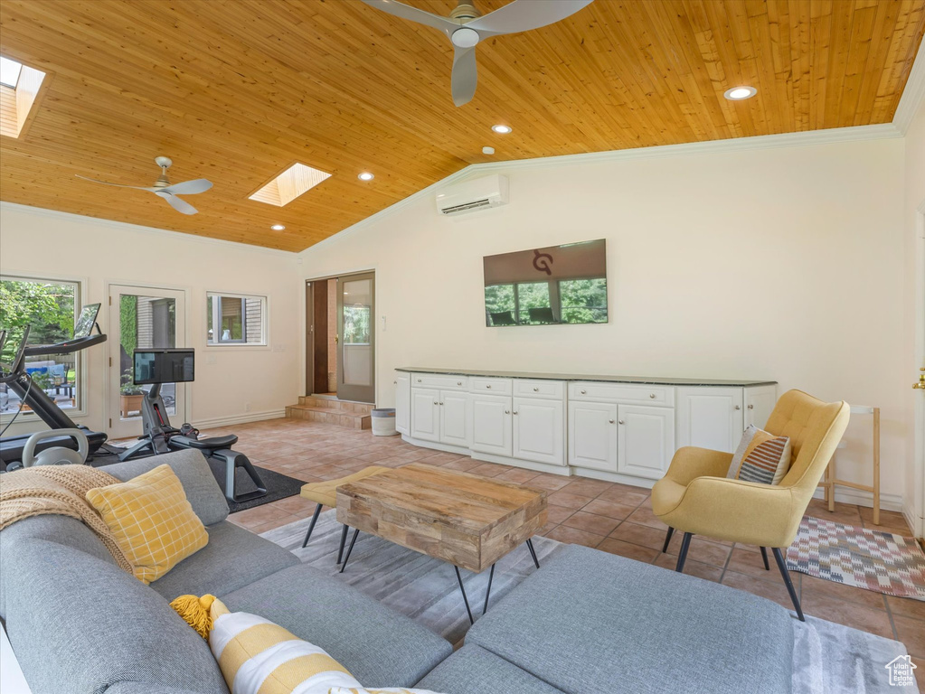 Living room with wooden ceiling, vaulted ceiling with skylight, ceiling fan, light tile patterned floors, and a wall unit AC