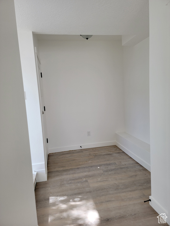 Empty room featuring wood finished floors and baseboards