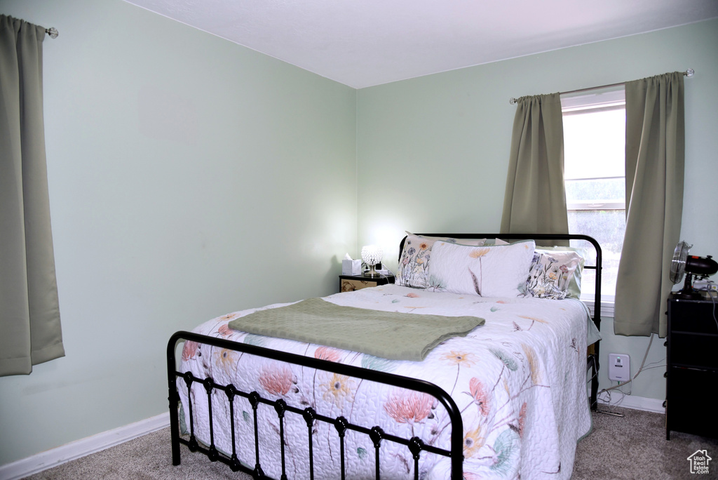 Carpeted bedroom featuring baseboards