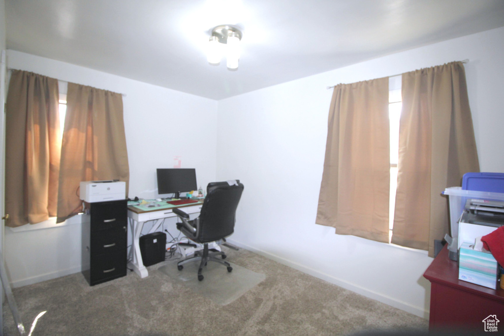 Carpeted office space featuring baseboards