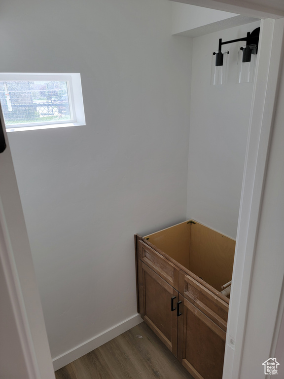 Bathroom with wood finished floors and baseboards