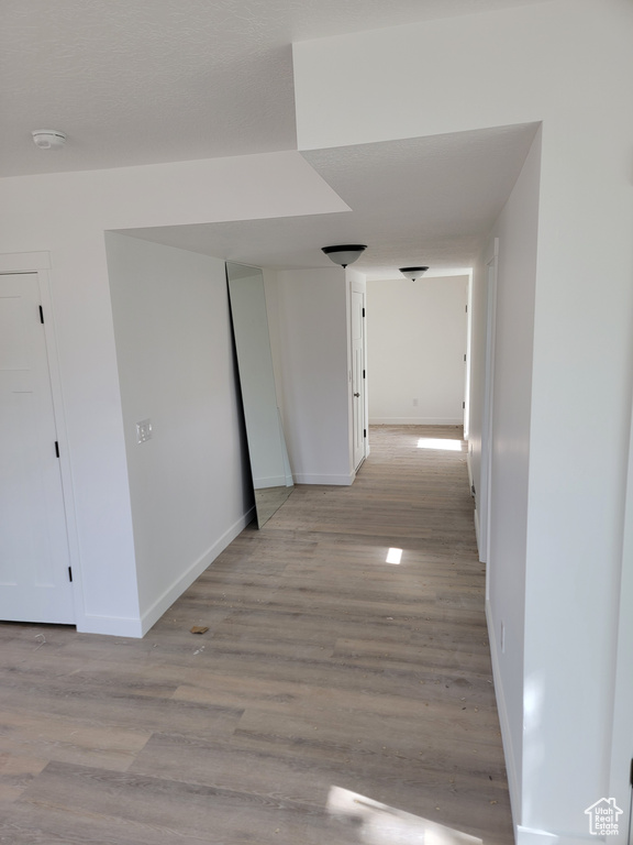Hall featuring baseboards and light wood-type flooring