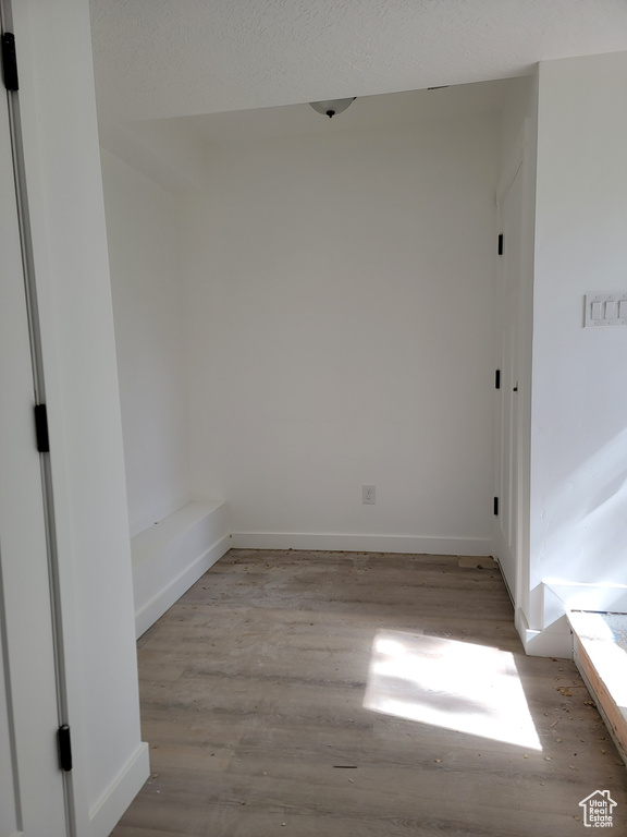 Unfurnished room with light wood-style flooring and baseboards