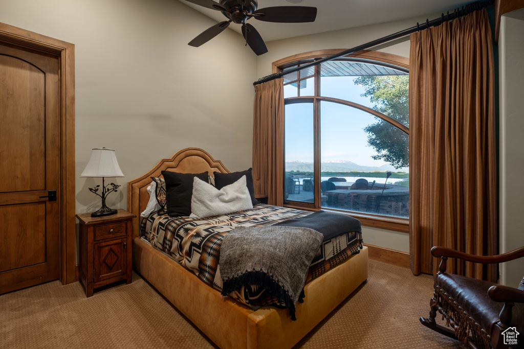 Bedroom featuring light colored carpet and a ceiling fan