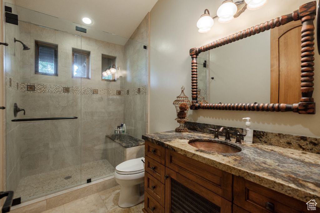 Full bathroom with vanity and a shower stall