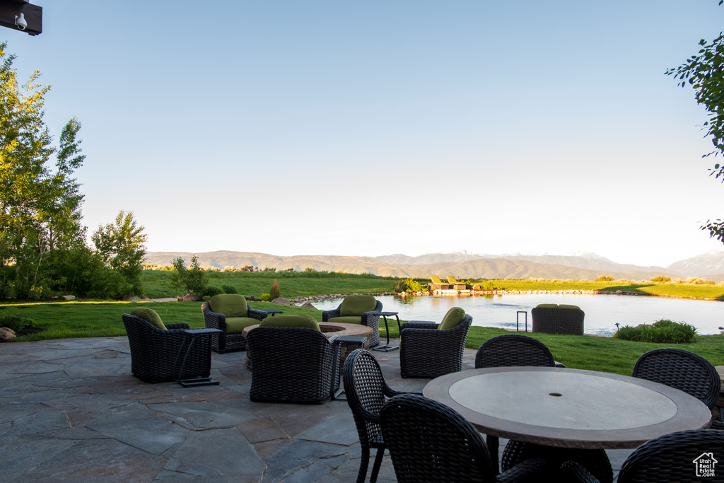 View of patio with a water and mountain view