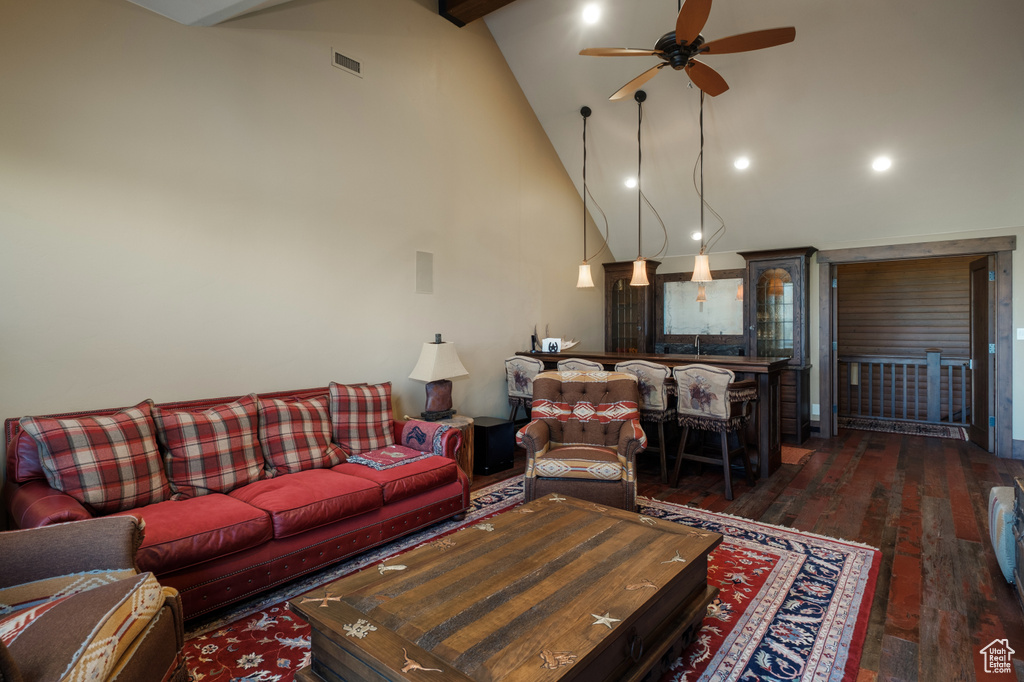 Living room with a ceiling fan, hardwood / wood-style flooring, high vaulted ceiling, beamed ceiling, and recessed lighting
