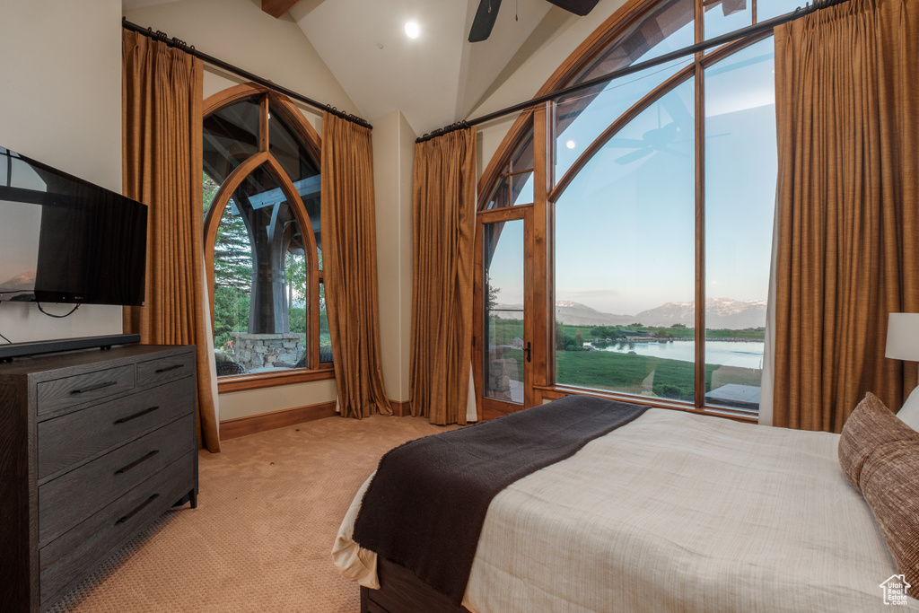 Bedroom with vaulted ceiling, access to exterior, light colored carpet, a water and mountain view, and ceiling fan