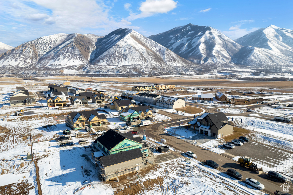 Snowy aerial view featuring a residential view and a mountain view