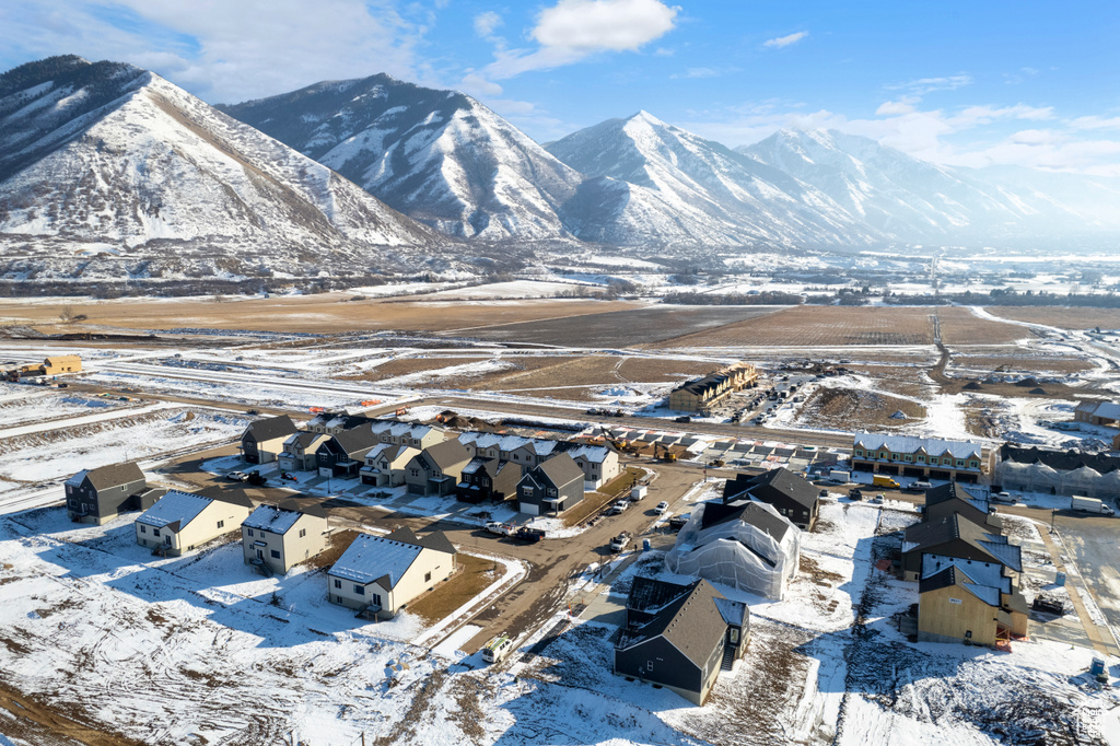 Snowy aerial view with a residential view and a mountain view