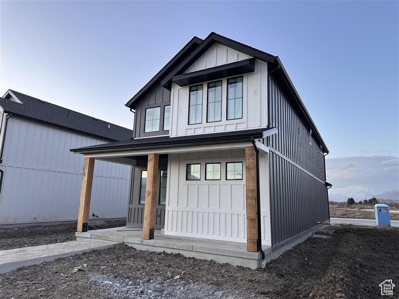 View of front of property featuring covered porch and board and batten siding