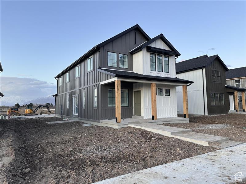 Modern farmhouse style home with a porch and board and batten siding
